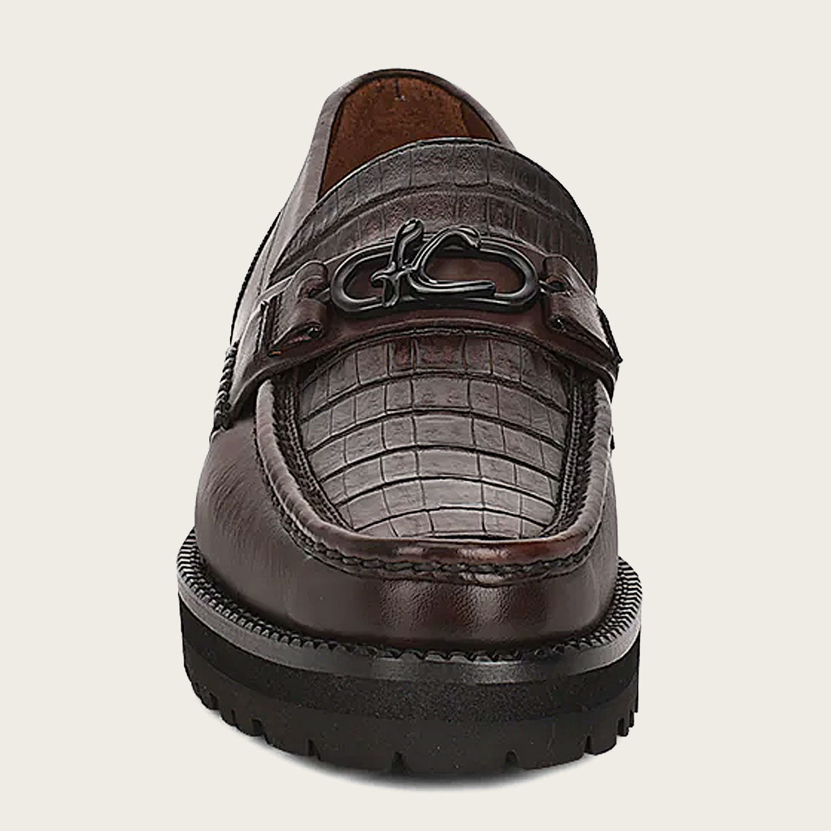 carefully sewed by hand the front of the leather loafer