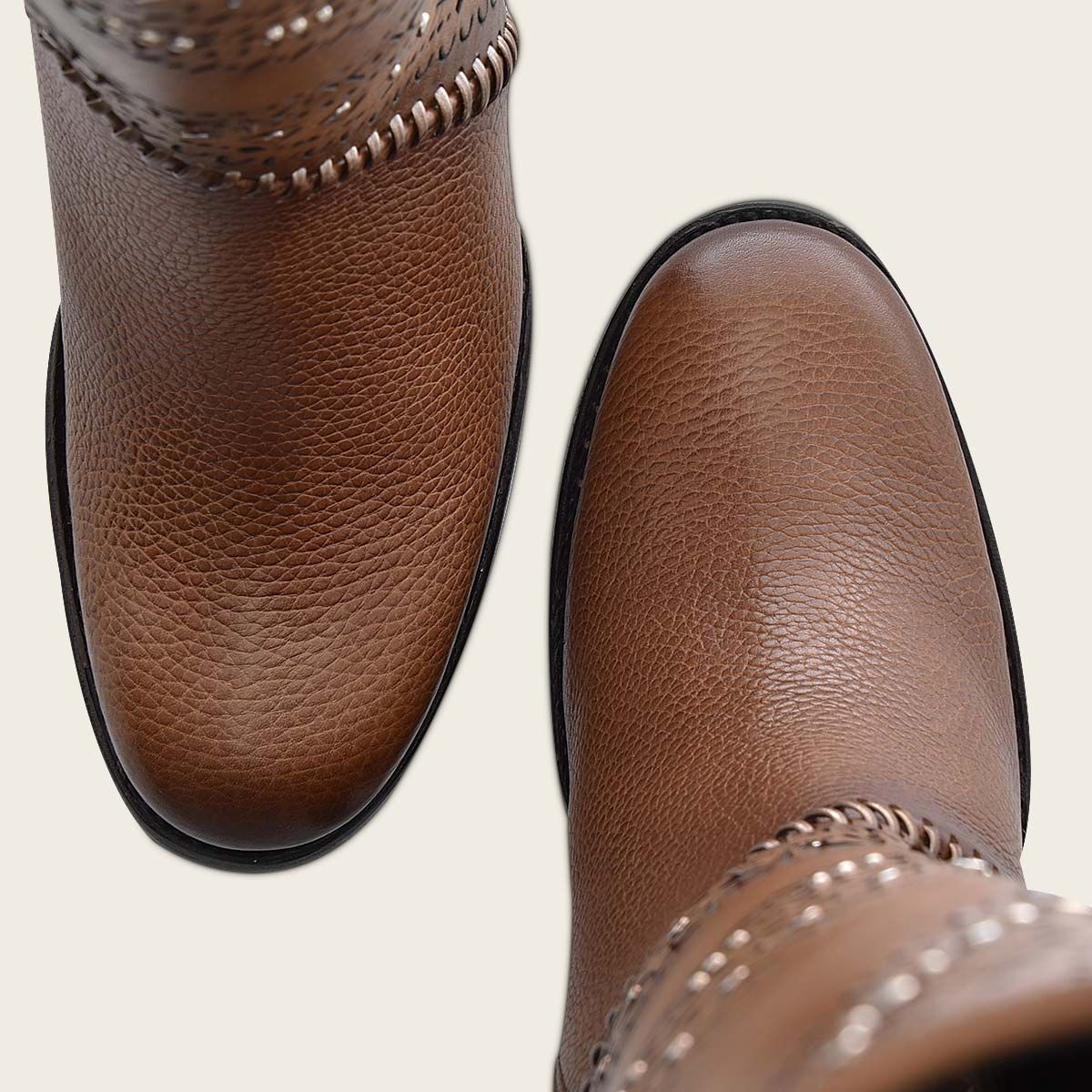 Decorated brown leather tall boot with perforations