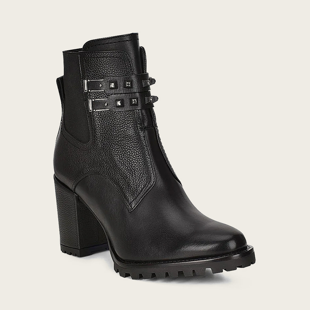 Crafted with bovine leather, the bootie features studded straps with genuine crystals