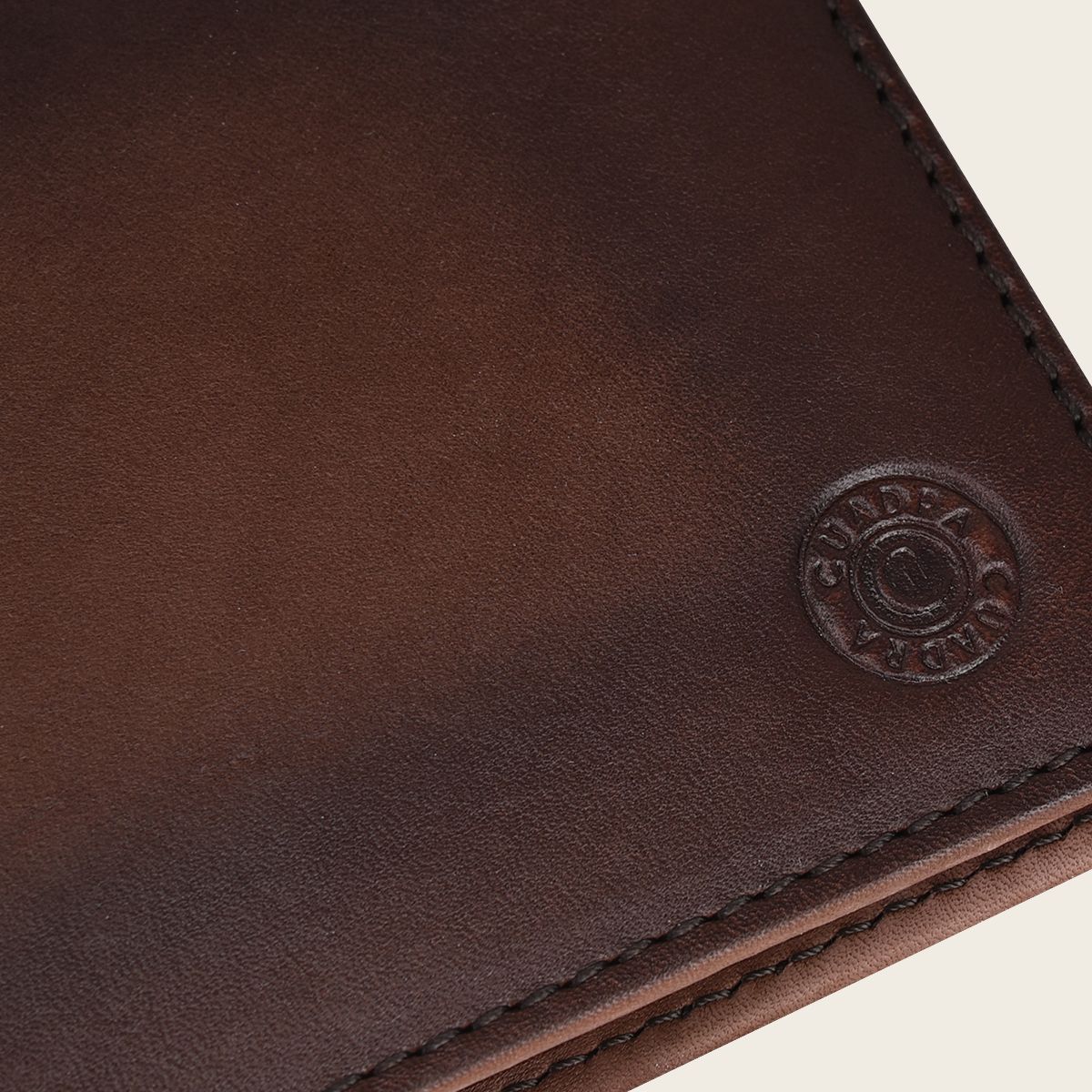On the front, you'll notice a tasteful engraving of the Cuadra monogram, adding a touch of sophistication to your everyday accessory.