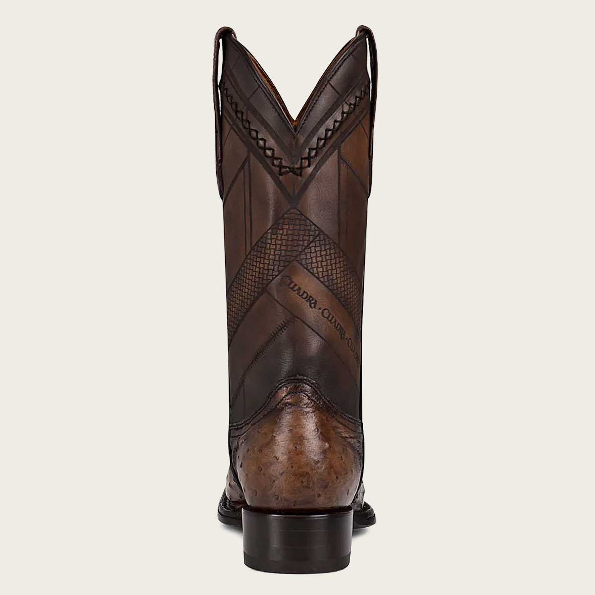 Stylish men's dark brown leather boots with intricate laser-engraved details and expert craftsmanship