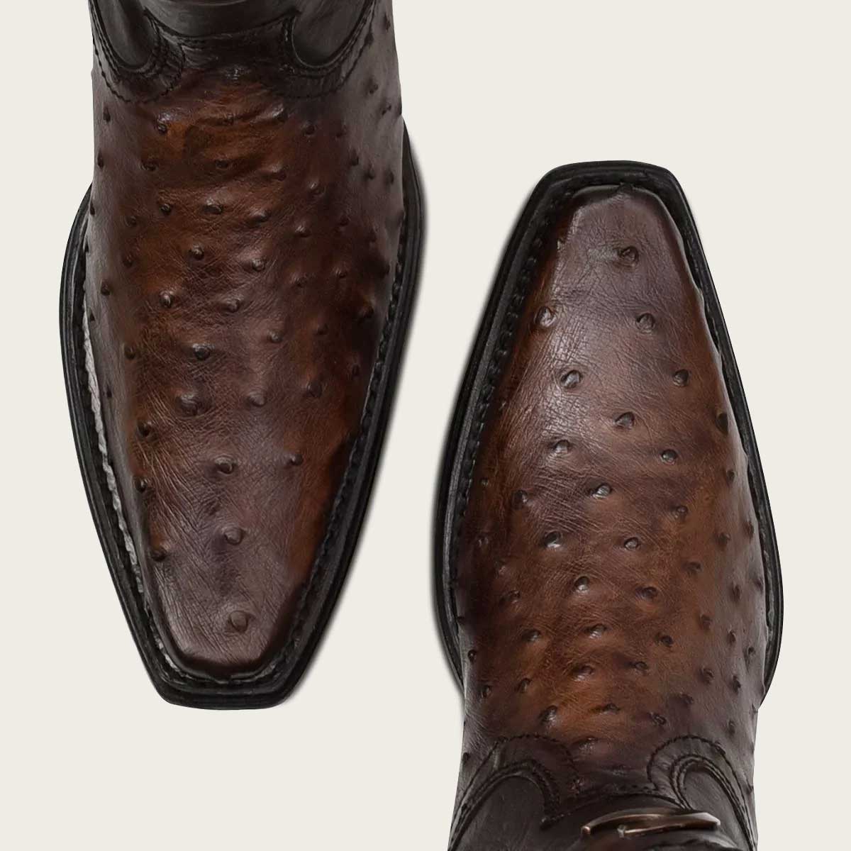 Stylish men's dark brown leather boots with intricate laser-engraved details and expert craftsmanship
