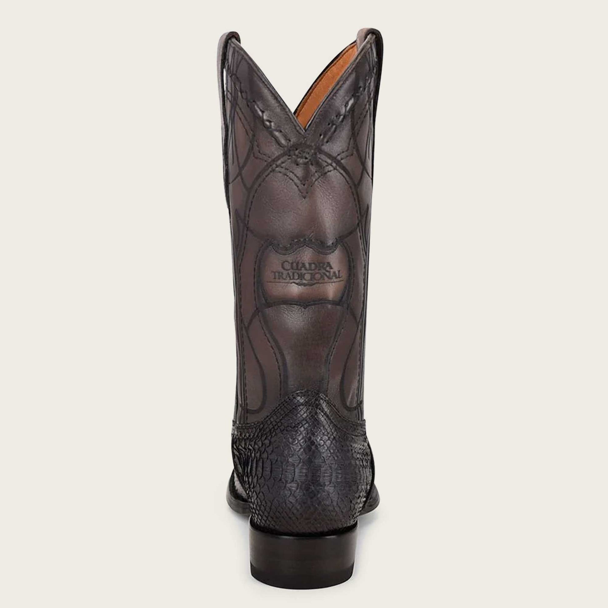 Stylish black python leather Western boot with intricate engraving and striking embroidery on the shaft.