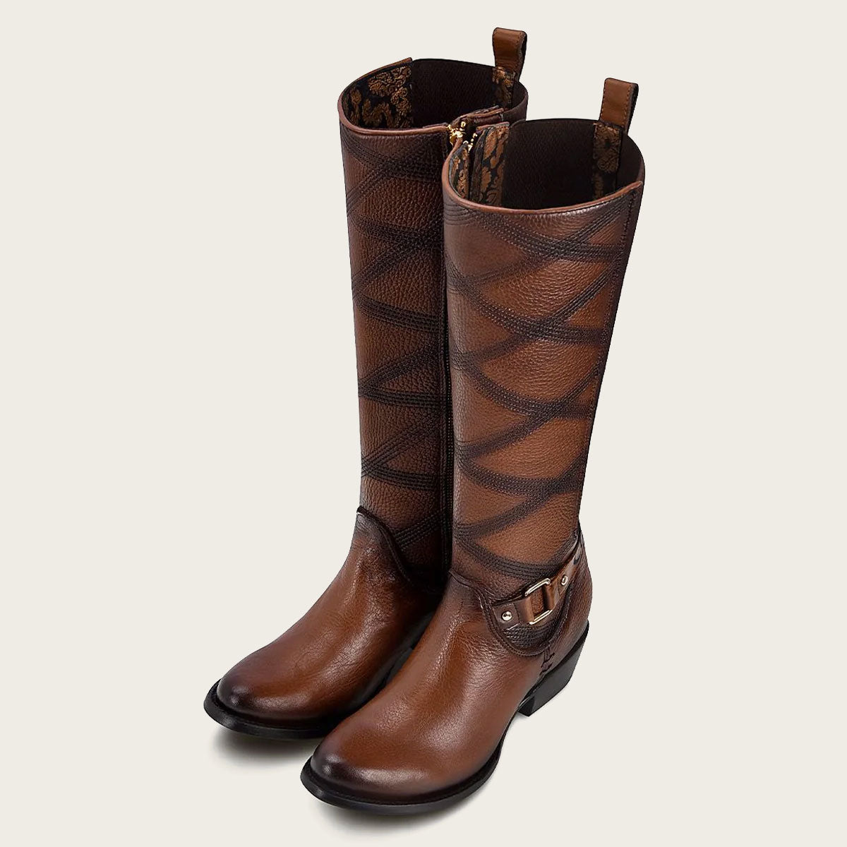 A beautiful honey-colored leather boot with intricate embroidery, perfect for adding a touch of elegance to any outfit.