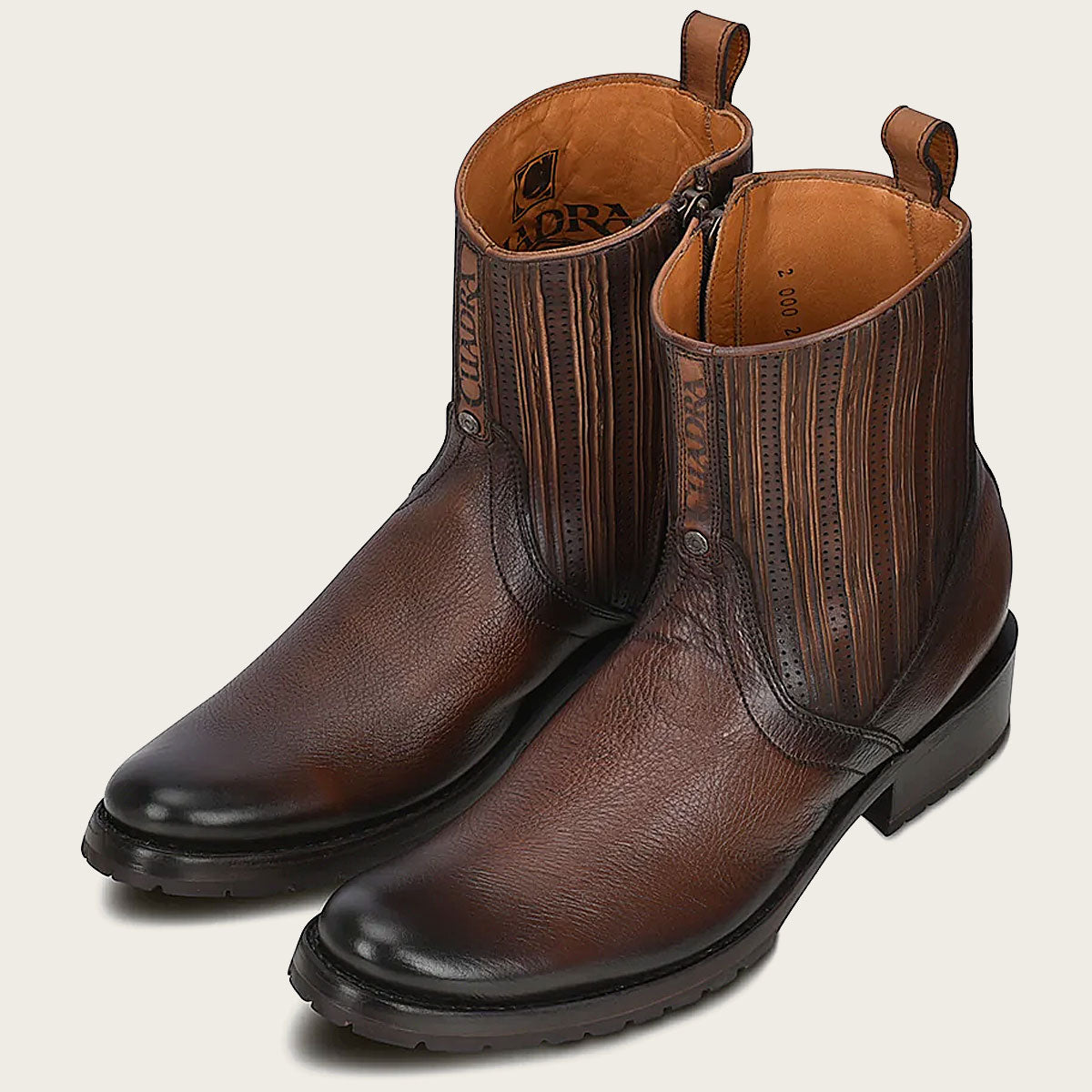 Hand-painted honey leather men's boot with engraved logo and perforated details