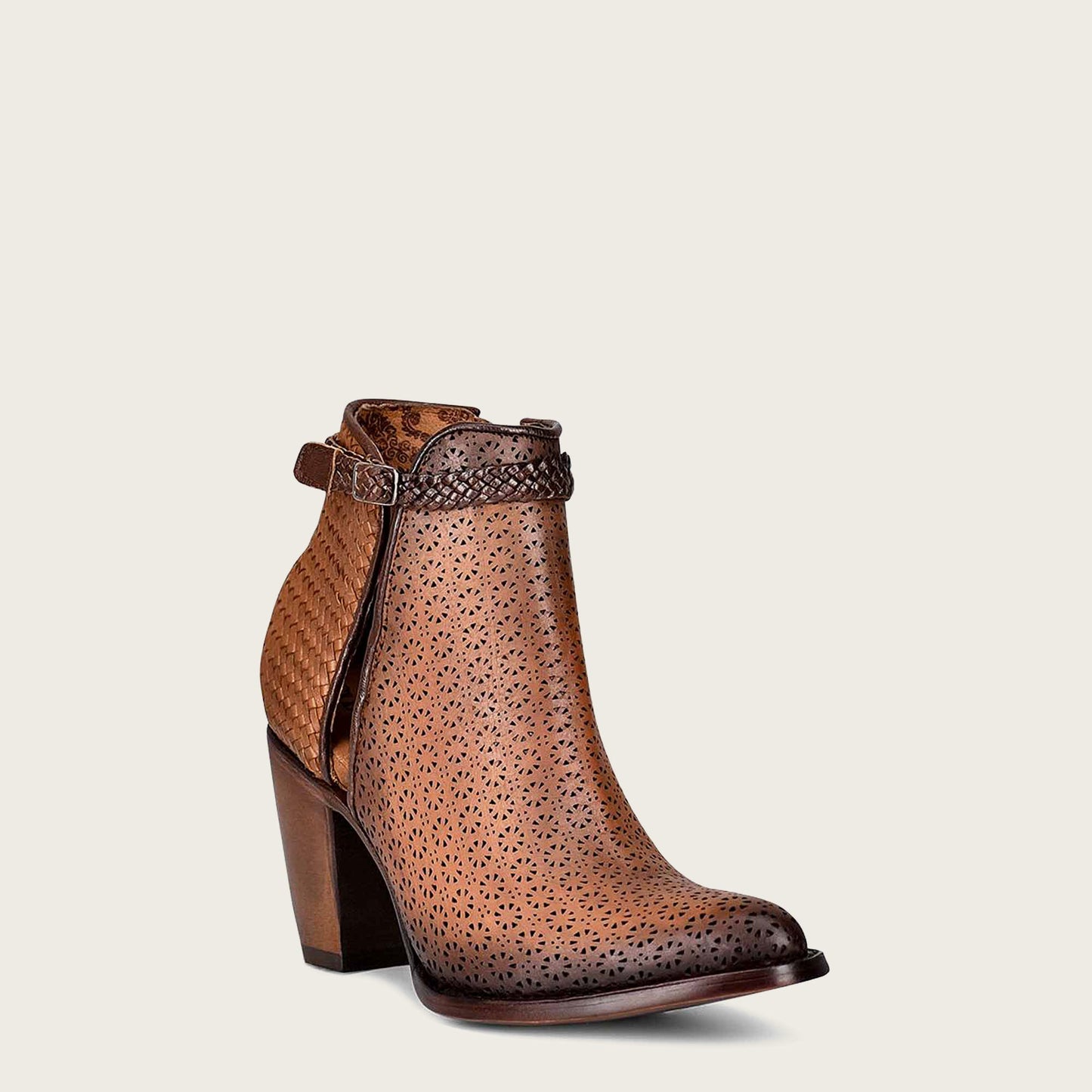 Step up your style game with these chic brown leather booties featuring intricate perforated details and a hand braided ankle strap.