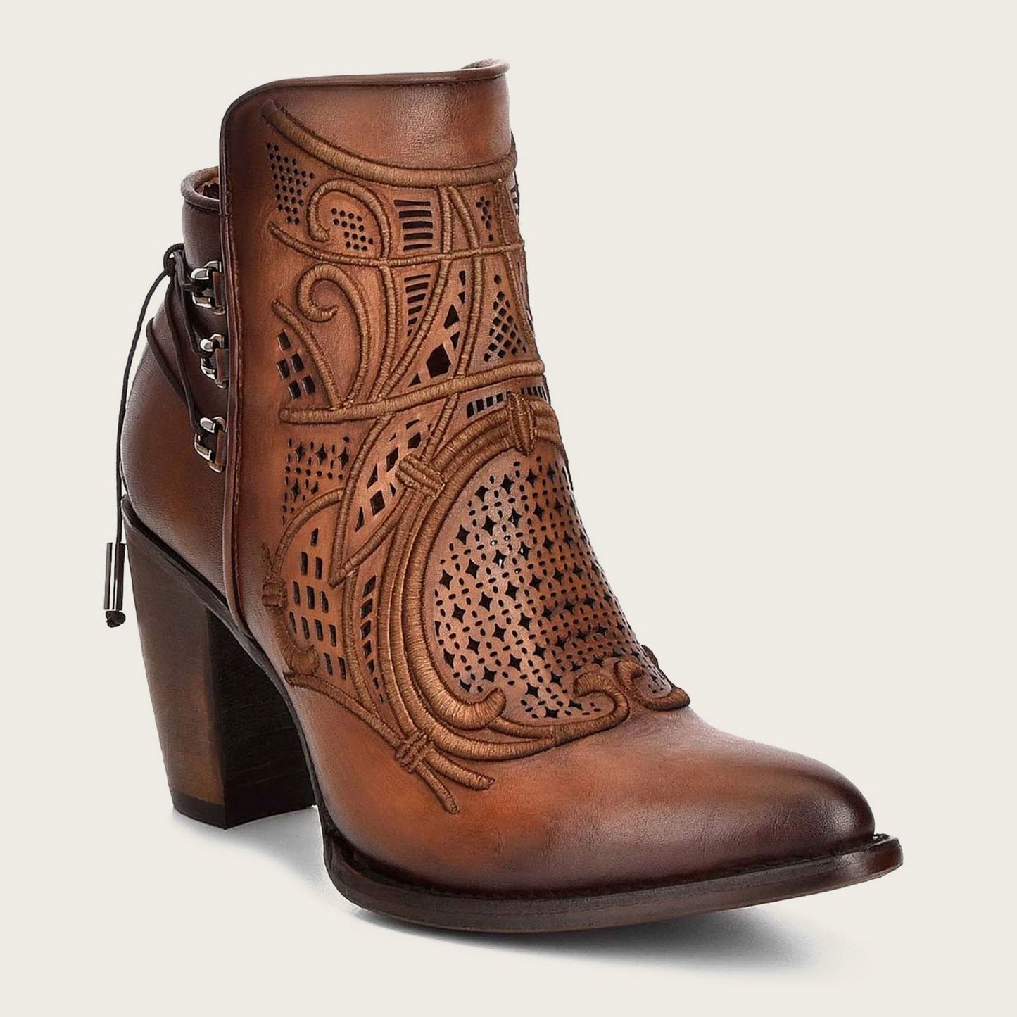 Embroidered honey leather bootie with organic motifs and metallic details.