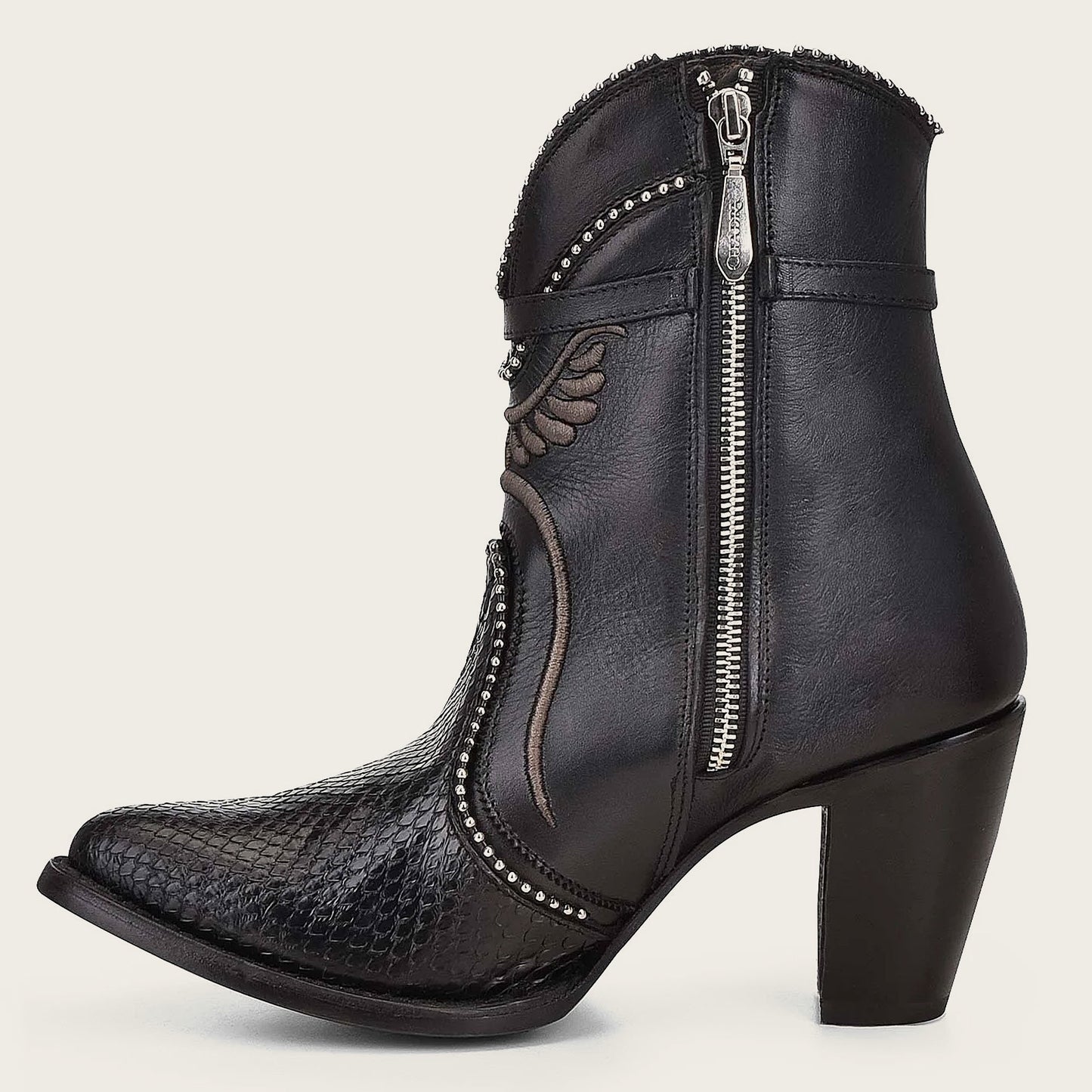 These boots combine style and practicality with a leather strap, metallic buckle, and inner zipper for easy on-and-off