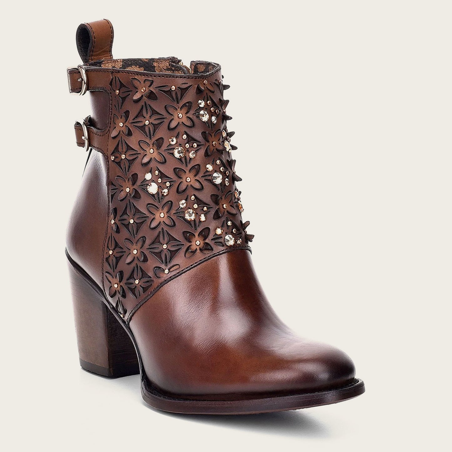 Handcrafted perforated brown leather bootie adorned with Austrian crystals.