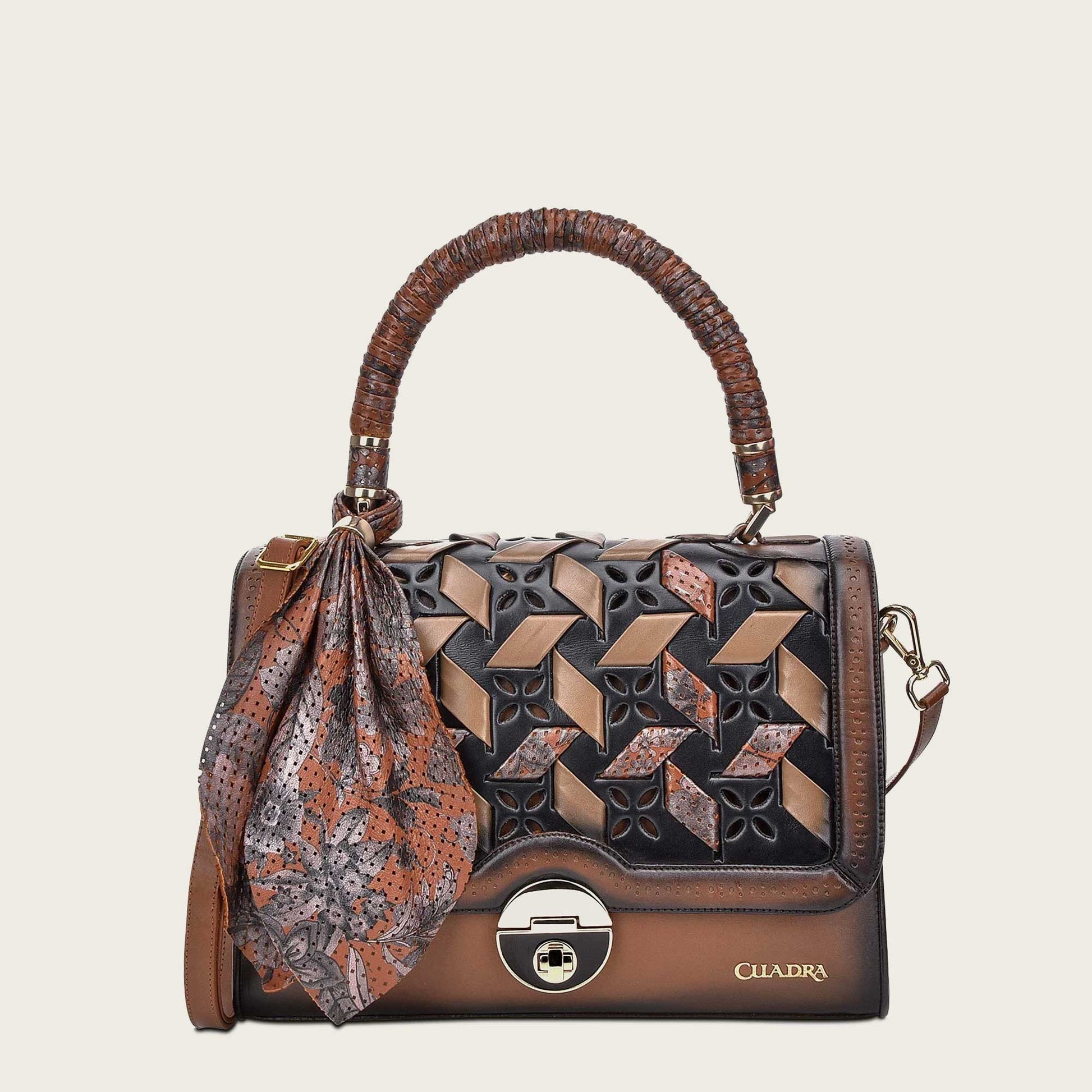 Printed brown leather satchel bag, for women in bovine leather. Perforated with organic motifs, with bovine leather and an ovine leather bandana.