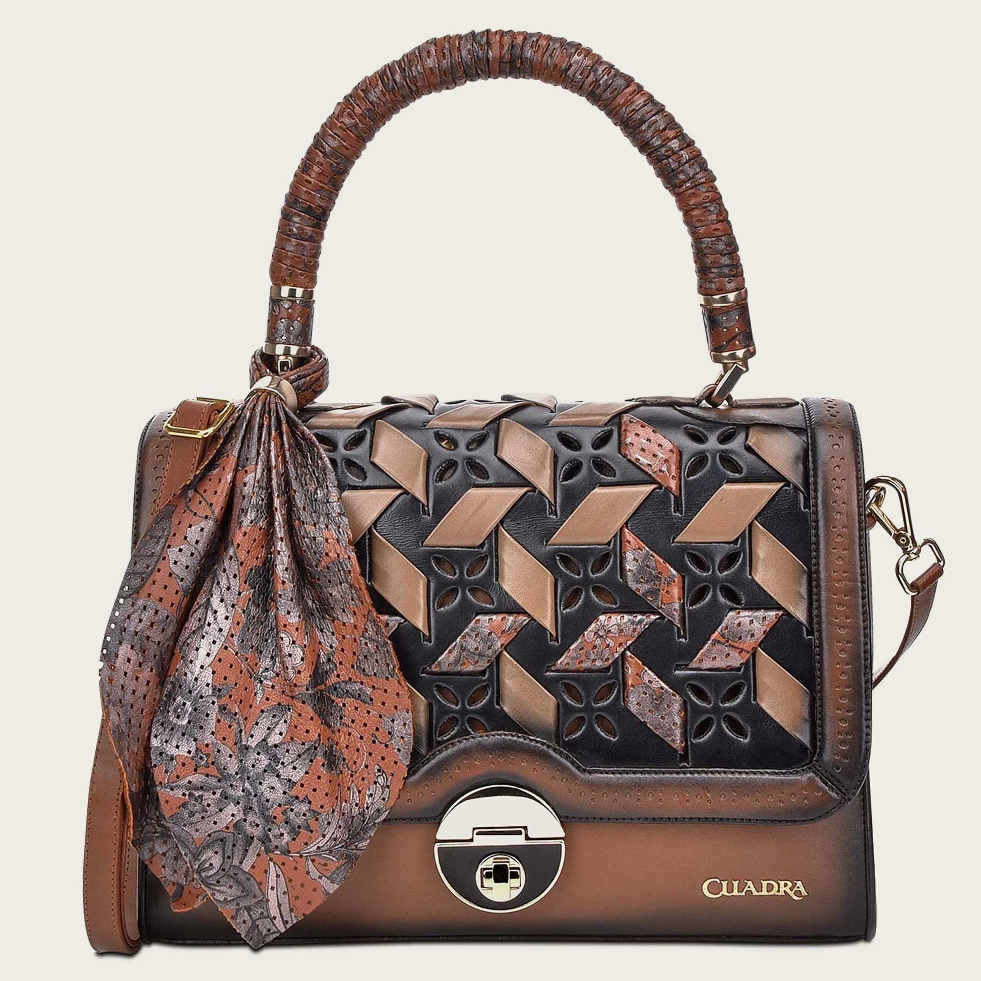 The front flap boasts a stunning perforated design with intricate organic motifs, carefully woven using bovine leather. 