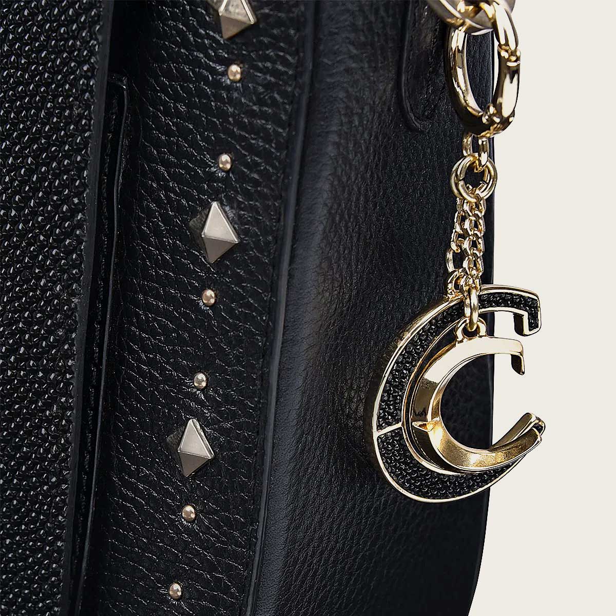 Elevate your style with this black handbag crafted from genuine stingray leather, adorned with studs for a chic and edgy look.