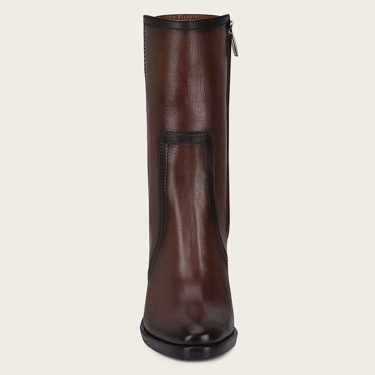 Brown leather bootie with metallic symbol on side. Smooth, polished leather, block heel, high ankle shaft, intricate design.